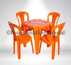 an orange table and four chairs with the word sun on it