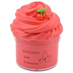 a pink cupcake in a plastic container with cherries on top and the words cherry fluffy slime written below it