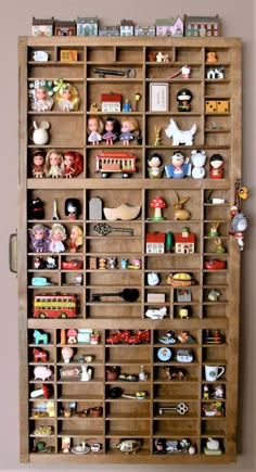 a wooden shelf filled with lots of toy figurines