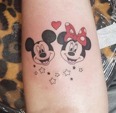 two mickey and minnie mouse tattoos on the arm