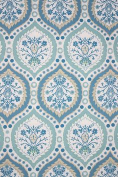 a blue and white wallpaper with an ornate design on it's surface,