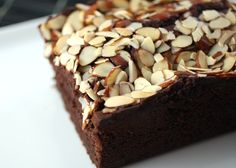 a piece of chocolate cake with nuts on top