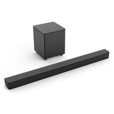 the sound bar is next to a black box on a white surface with an object behind it