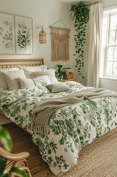 a bed with green leaves on it in a bedroom next to a window and wicker chair