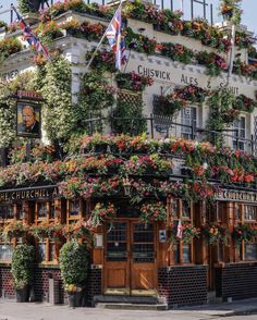 the outside of a building with flowers growing on it