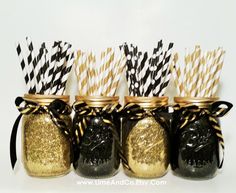 black and gold mason jars with paper straws in them