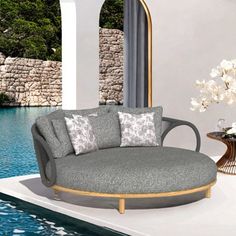 a round couch sitting on top of a white floor next to a pool