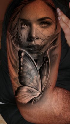 a man with a butterfly tattoo on his arm and shoulder is shown in black and white