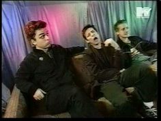 three men sitting on a couch with their mouths open