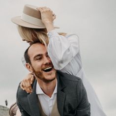 a man carrying a woman on his back