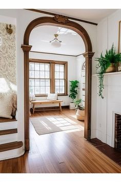 a living room filled with furniture and a fire place in front of a fireplace covered in potted plants