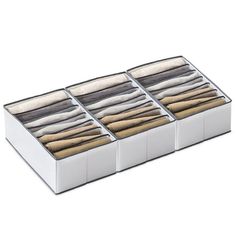 four drawers with folded clothes in them on a white background, each containing an individual's shirt and pants