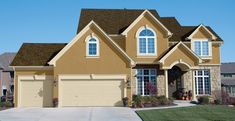 a large house with two garages in the front and one on the other side