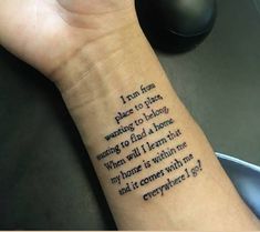 a person's wrist with a poem written on it