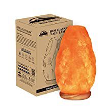 an orange himalayan salt lamp sitting next to a box