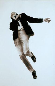 a black and white photo of a man jumping in the air