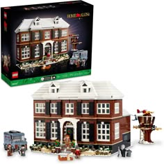 a lego set with a large brick building and fire station in front of it's box