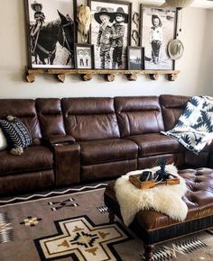 a living room with brown leather furniture and pictures on the wall above it's couch