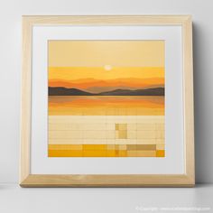 an orange and yellow painting hangs on the wall next to a white shelf with a wooden frame