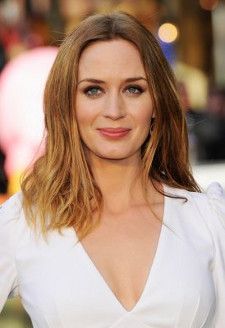 a close up of a person wearing a white dress and posing for the camera with her hands on her hips