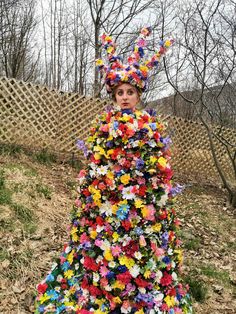 a woman in a colorful dress made out of flowers