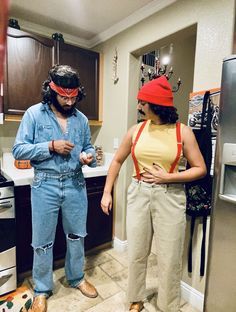 two people standing in a kitchen wearing costumes