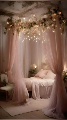 a canopy bed with pink drapes and lights on the headboard is decorated with flowers