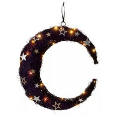 a purple wreath with white stars hanging from it's side and the letter c on top