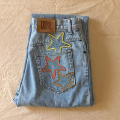 "Reworked vintage light wash mom jeans. These jeans are reworked with handmade star patches in a mainly yellow and orange color pallate.  All pockets are fully functional.  Original jeans are by Liz Wear. 100% cotton, made in Phillipines.  Marked a size 10 Petite- 29\" waist, 11.5\" rise, 39\" hips, 26\" inseam, 14\" leg opening.  In great vintage condition with some very light vintage wear." Patchwork Star, Light Wash Mom Jeans, Star Patches, Patchwork Hoodie, Reworked Denim, Patchwork Clothes, Star Vintage, Vintage Mom Jeans, Diy Jeans