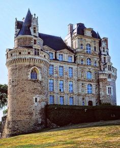 an old castle like building on top of a hill