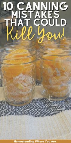 jars filled with oranges sitting on top of a table