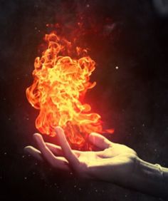 a person holding out their hand with fire in the air above it and on top of them