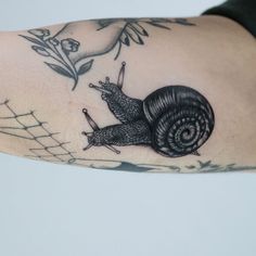 a black and white photo of a snail on the arm