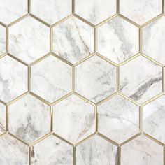 marble hexagon tiles with gold trims are shown in this tile pattern, which is