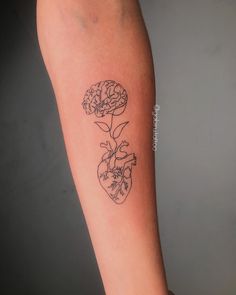 a woman's arm with a flower and heart tattoo on the left inner forearm