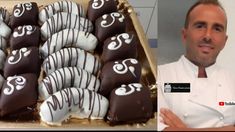 a man standing next to a box filled with chocolate covered desserts on top of a table