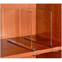 two clear acrylic shelves on top of a wooden shelf with metal brackets in the middle