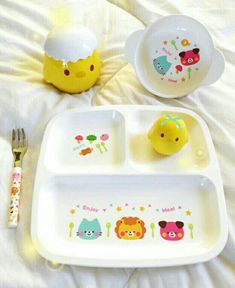 a child's meal set on a bed with utensils