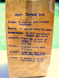 a brown paper bag sitting on top of a table next to a green grass covered field