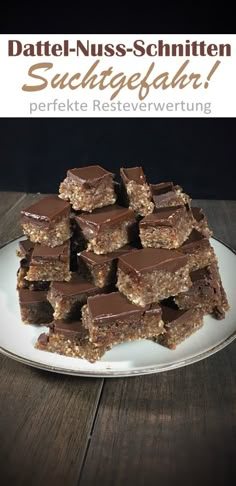 there is a white plate with chocolate bars stacked on it and the words date - nuss - schniten succupfahle