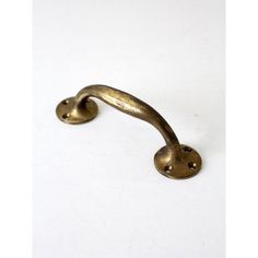 an antique brass door handle on a white background