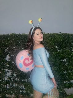 a woman in a blue dress holding a balloon