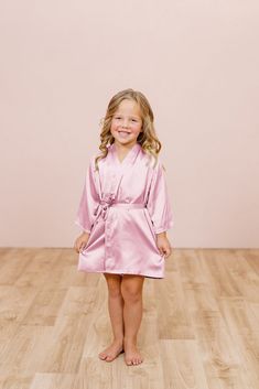 A mini match made just for your little ones! Our made-to-order robes are a perfect match with your bridesmaid dresses and wedding colors. With loose three-quarter bell sleeves and a satin ribbon that self-ties at the center of your waist, this is the perfect robe for your kids and juniors to participate in your glam morning! Feather Bridesmaid Robes, White Robe For Kids, Pink Satin Spring Robe, Elegant Pink Bridesmaid Robe, Flower Girl Robes, Wedding Parties Colors, Dusty Blue Wedding, Dusty Blue Weddings, Blush Bride