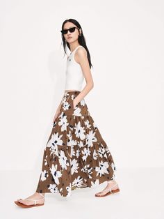 MO&Co. Women's Tiered Floral Print Maxi Skirt This luxurious piece features a feminine maxi length and flowy fit, along with a high waist and pleated design. Plus, a concealed side zipper closure and bold floral print add the finishing touches for a standout look. Features : - Maxi length and flowy fit- High waist and pleated details- Concealed side zipper closure- Floral printed design Code: MBC2SKTT09The back length of size S is 85.5cmMATERIALS & CARE Material: 68.5% Cotton 27.5% Polyamide 4% Day Out Full Ruffled Maxi Skirt, Day Out Full Maxi Skirt With Ruffles, Spring Relaxed Fit Tiered Maxi Dress, Spring Tiered Maxi Skirt, Spring Full Flowy Maxi Skirt, Spring Flowy Full Maxi Skirt, Spring Voluminous Lined Maxi Skirt, Spring Lined Maxi Skirt, Floral Print Long Maxi Skirt For Day Out