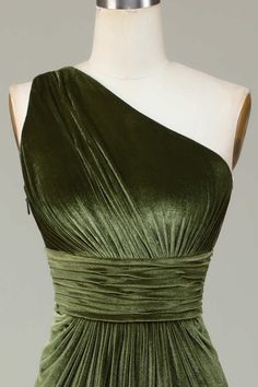 a green dress on a mannequin with one shoulder draped over the top and an open back