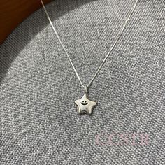 This simple and delicate smiley star pendant necklace is made of 925 silver With a delicate chain Showing a gentle and lovely design style The star-shaped pendant is engraved with a smiling expression Adds a unique flavor to the whole necklace This necklace is perfect for daily wear Whether layered or worn alone This necklace is perfect for everyday wear. Whether it's a gift for yourself or a friend This necklace conveys beauty and happiness The star symbolizes dreams and hope. Bringing you more positive energy Hope you like it. Silver Everyday Necklace, Silver Necklace Stack, Fashion Jewelry Editorial, Smiley Necklace, Gifts For Friends Christmas, Friends Christmas Gifts, Smiling Expression, Silver Star Necklace, Simple Necklaces