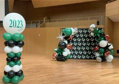 balloons and decorations in the shape of footballs are on display at an indoor event