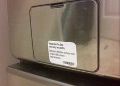 a stainless steel refrigerator with a sign on the door saying it is not safe to use