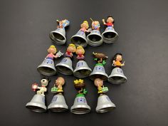 small toy figurines are arranged in the shape of bells