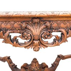 an ornate wooden table with carved carvings on the top and bottom, against a white background